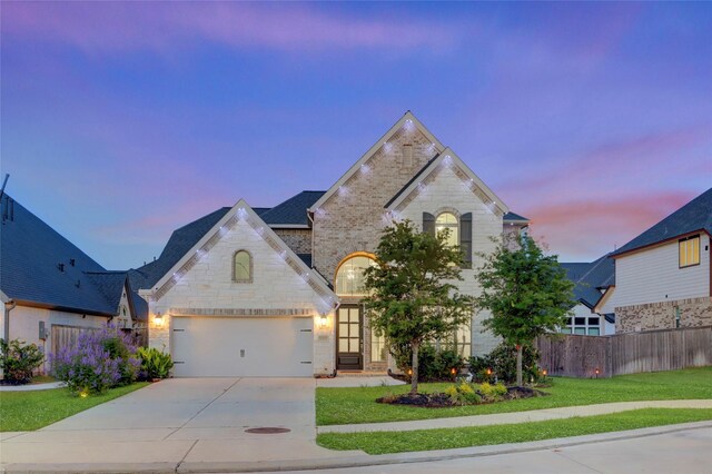 2327 Partridgeberry Ln, Katy, TX 77494 - french country style house with stone siding, driveway, brick siding, and a garage