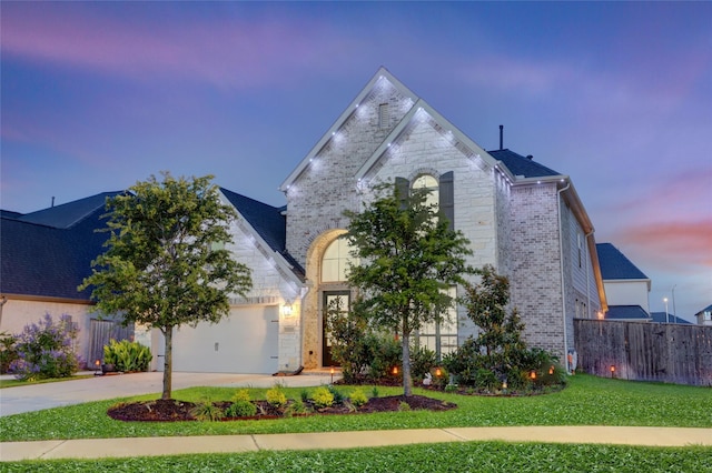 2327 Partridgeberry Ln, Katy, TX 77494 - french country style house with stone siding, concrete driveway, brick siding, and a garage
