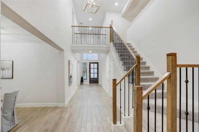 2327 Partridgeberry Ln, Katy, TX 77494 - entryway with a towering ceiling, wood finished floors, stairs, a chandelier, and recessed lighting
