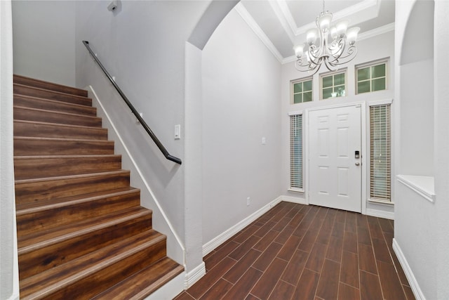 21606 Hansom Dr, Porter, TX 77365 - entrance foyer featuring arched walkways, ornamental molding, baseboards, stairway, and a chandelier