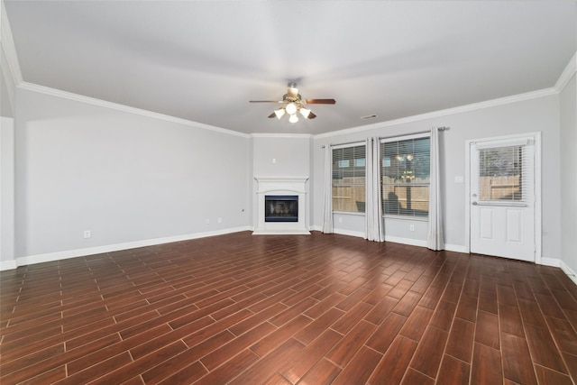 21606 Hansom Dr, Porter, TX 77365 - unfurnished living room featuring ceiling fan, baseboards, ornamental molding, a glass covered fireplace, and dark wood-style floors