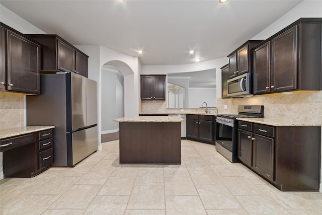 21606 Hansom Dr, Porter, TX 77365 - kitchen featuring stainless steel appliances, dark brown cabinets, backsplash, and recessed lighting