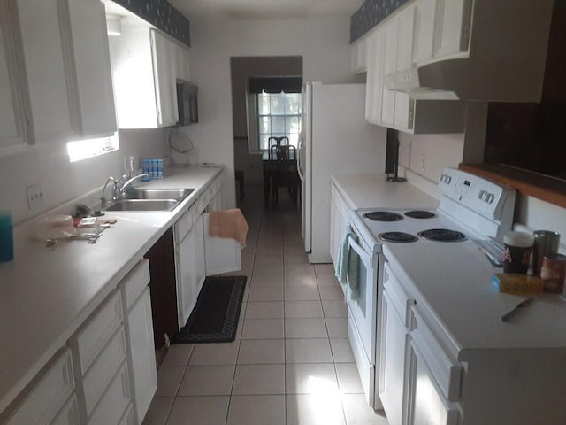 4927 Algernon Dr, Spring, TX 77373 - kitchen with white appliances, a sink, healthy amount of natural light, and range hood