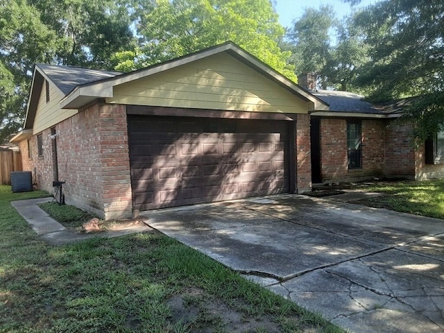 4927 Algernon Dr, Spring, TX 77373 - view of front of home with an attached garage, brick siding, concrete driveway, central AC, and a chimney