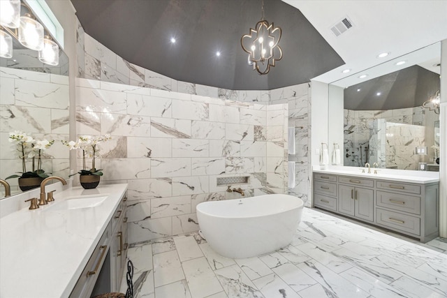 4323 Colony W Dr, Richmond, TX 77406 - bathroom featuring tile walls, a marble finish shower, marble finish floors, two vanities, and a chandelier