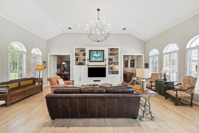 4323 Colony W Dr, Richmond, TX 77406 - living area with plenty of natural light, a chandelier, light wood-style flooring, ornamental molding, and high vaulted ceiling