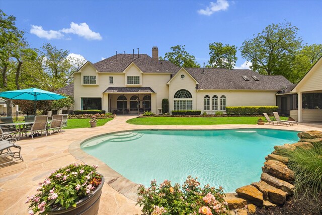 4323 Colony W Dr, Richmond, TX 77406 - swimming pool with a sunroom, a patio, and a lawn