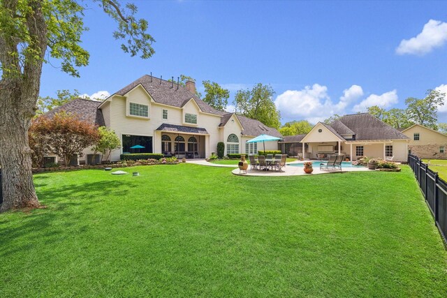4323 Colony W Dr, Richmond, TX 77406 - back of house with a patio area, a chimney, and a shingled roof