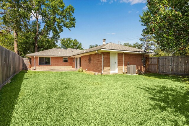 1803 Latexo Dr, Houston, TX 77018 - back of property featuring central AC unit, brick siding, a patio area, and roof with shingles