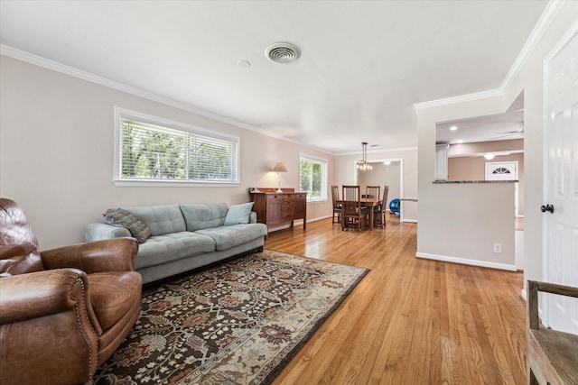 1803 Latexo Dr, Houston, TX 77018 - living area with ornamental molding, light wood finished floors, baseboards, and a chandelier