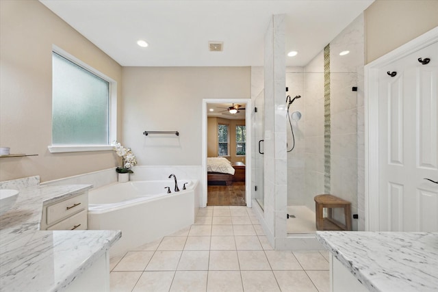 12151 Oak Hvn W, Magnolia, TX 77354 - full bath featuring a shower stall, a garden tub, a ceiling fan, ensuite bath, and tile patterned floors