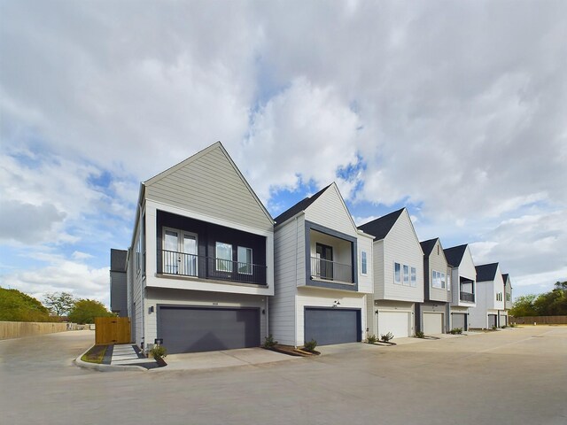 2710 Jensen Creek Ln, Houston, TX 77026 - view of front facade featuring an attached garage and a balcony