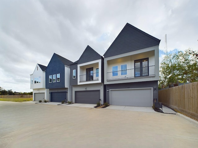 2710 Jensen Creek Ln, Houston, TX 77026 - view of front of house with a garage, a balcony, and concrete driveway