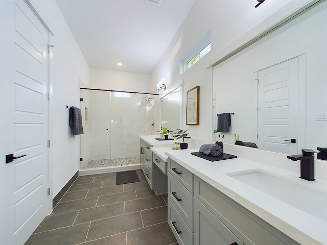 2710 Jensen Creek Ln, Houston, TX 77026 - bathroom featuring vanity, a marble finish shower, tile patterned flooring, and recessed lighting