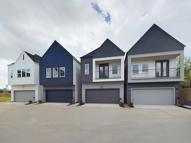2710 Jensen Creek Ln, Houston, TX 77026 - view of front facade with a garage, a balcony, and driveway