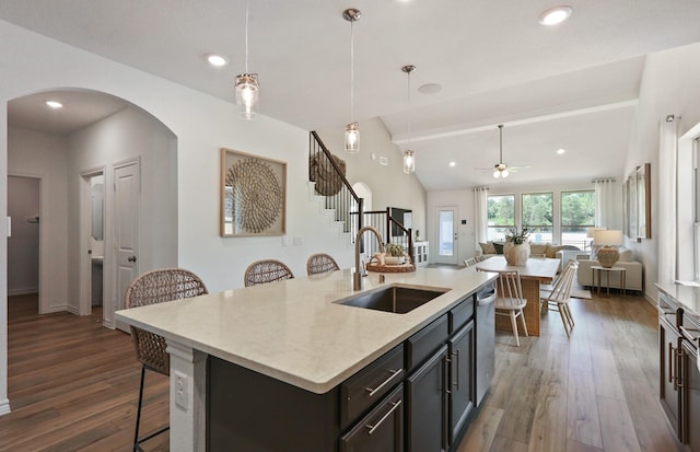 25701 Damask Dr, Magnolia, TX 77355 - kitchen featuring a sink, ceiling fan, a kitchen breakfast bar, stainless steel dishwasher, and arched walkways