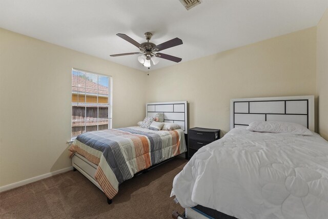 1314 Robert St, Baytown, TX 77521 - bedroom featuring dark carpet, baseboards, and a ceiling fan