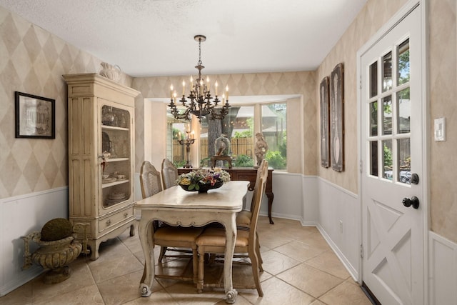 5610 Edgewick Ct, Houston, TX 77069 - dining area featuring wallpapered walls, a chandelier, wainscoting, and light tile patterned floors