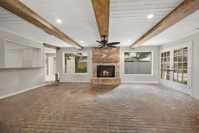 5610 Edgewick Ct, Houston, TX 77069 - unfurnished living room featuring brick flooring, a brick fireplace, ceiling fan, beamed ceiling, and french doors