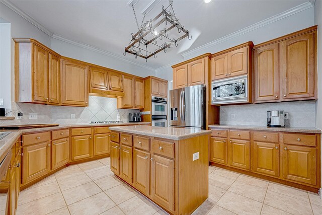 15614 Stable Brook Cir, Cypress, TX 77429 - kitchen featuring appliances with stainless steel finishes, crown molding, light tile patterned flooring, a chandelier, and a center island