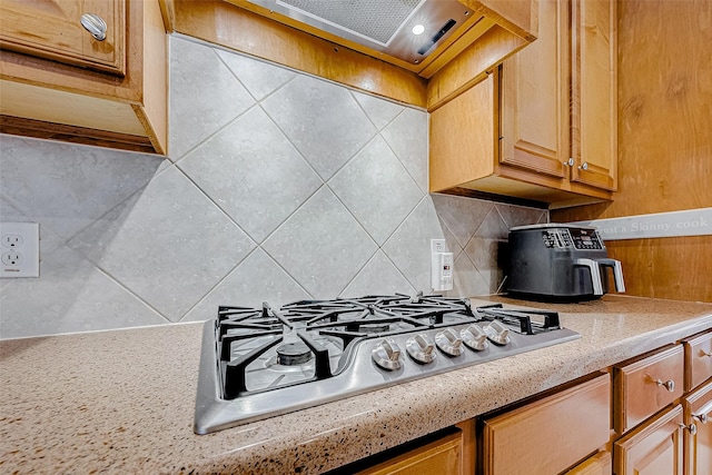 15614 Stable Brook Cir, Cypress, TX 77429 - kitchen with stainless steel gas cooktop, light countertops, backsplash, and range hood