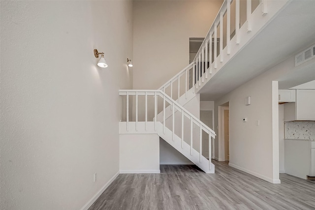 12632 Newbrook Dr, Houston, TX 77072 - stairs featuring wood finished floors, baseboards, and a high ceiling