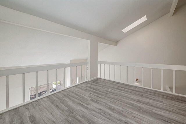 12632 Newbrook Dr, Houston, TX 77072 - unfurnished room featuring a skylight, wood finished floors, and lofted ceiling