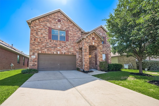 5018 Longlane Dr, Houston, TX 77084 - traditional-style home featuring a garage, driveway, a front yard, and brick siding