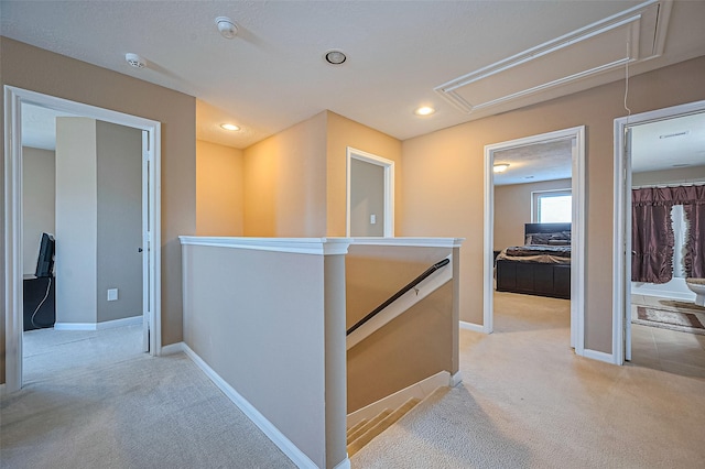 5018 Longlane Dr, Houston, TX 77084 - hall with attic access, an upstairs landing, light carpet, baseboards, and recessed lighting