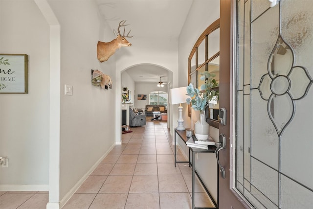 22607 August Crow Dr, Hockley, TX 77447 - hall with arched walkways, light tile patterned flooring, and baseboards