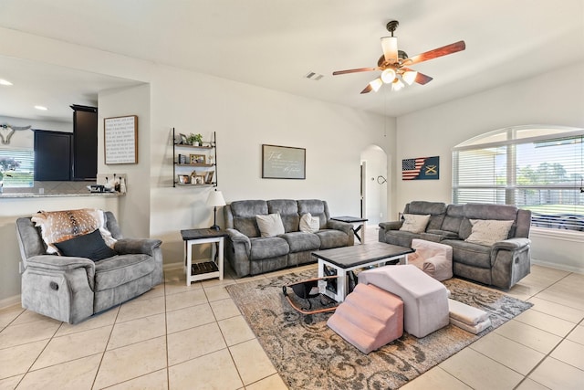 22607 August Crow Dr, Hockley, TX 77447 - living area with arched walkways, ceiling fan, light tile patterned flooring, baseboards, and recessed lighting