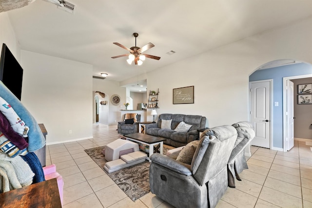 22607 August Crow Dr, Hockley, TX 77447 - living room with arched walkways, light tile patterned floors, a ceiling fan, and baseboards