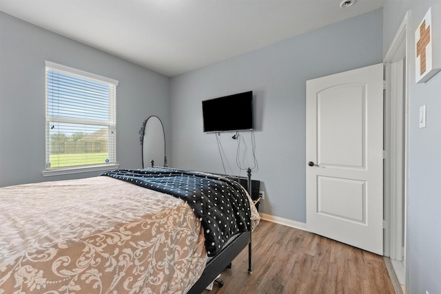 22607 August Crow Dr, Hockley, TX 77447 - bedroom featuring wood finished floors and baseboards