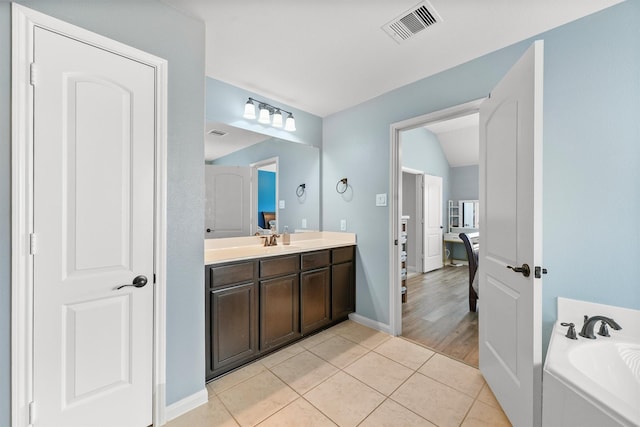 22607 August Crow Dr, Hockley, TX 77447 - full bath featuring tile patterned flooring, vanity, a bath, and baseboards