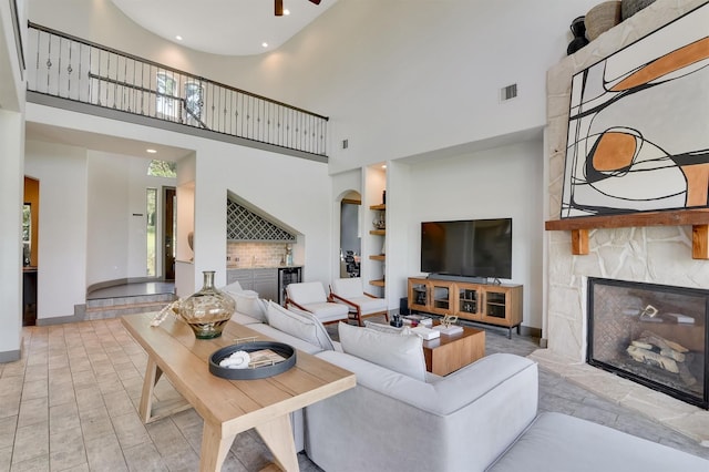 145 Grandview Blvd, Montgomery, TX 77356 - living area with a premium fireplace, a towering ceiling, built in shelves, baseboards, and recessed lighting