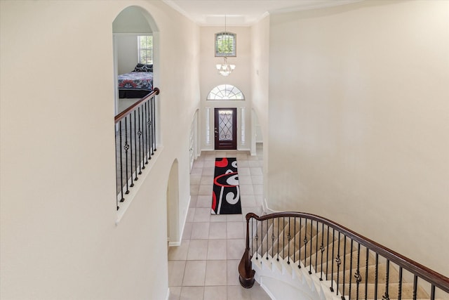 6015 Turner Shadow Ln, Sugar Land, TX 77479 - entrance foyer with light tile patterned floors, a chandelier, baseboards, ornamental molding, and stairway