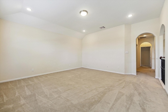 6015 Turner Shadow Ln, Sugar Land, TX 77479 - empty room with light colored carpet, arched walkways, recessed lighting, baseboards, and lofted ceiling