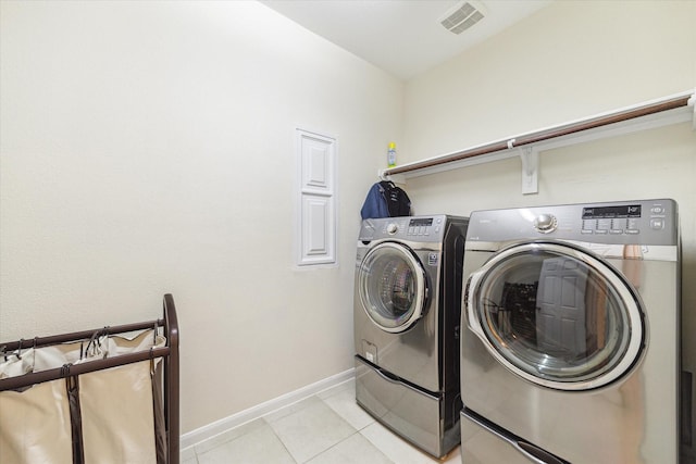 6015 Turner Shadow Ln, Sugar Land, TX 77479 - washroom featuring washer and clothes dryer, baseboards, and light tile patterned flooring