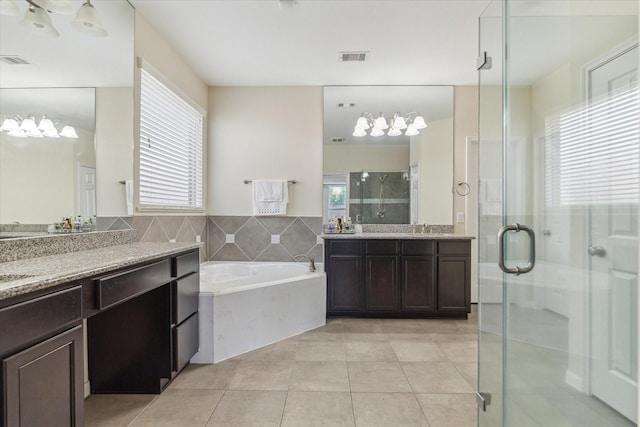 6015 Turner Shadow Ln, Sugar Land, TX 77479 - full bathroom with tile patterned flooring, a shower stall, a garden tub, two vanities, and a chandelier