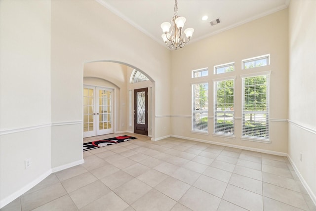 6015 Turner Shadow Ln, Sugar Land, TX 77479 - entrance foyer featuring light tile patterned floors, a chandelier, french doors, crown molding, and baseboards