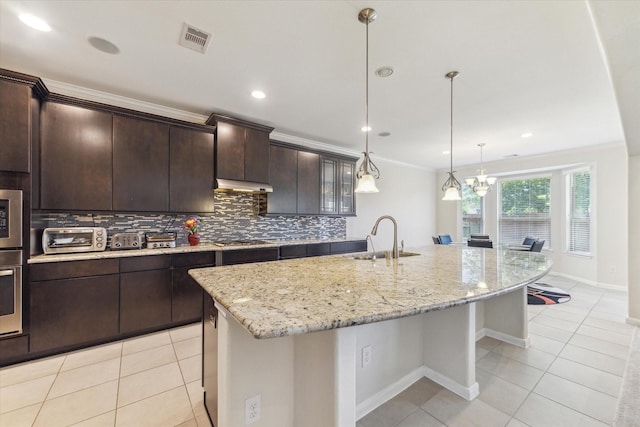 6015 Turner Shadow Ln, Sugar Land, TX 77479 - kitchen with a sink, under cabinet range hood, backsplash, light tile patterned floors, and crown molding