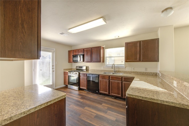 15531 Kiplands Bend Dr, Houston, TX 77014 - kitchen featuring black appliances, a sink, dark wood-style flooring, and light countertops