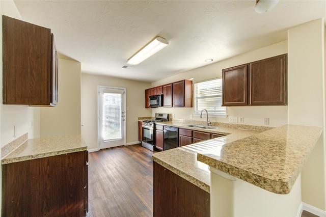 15531 Kiplands Bend Dr, Houston, TX 77014 - kitchen with black appliances, a sink, light countertops, a peninsula, and healthy amount of natural light