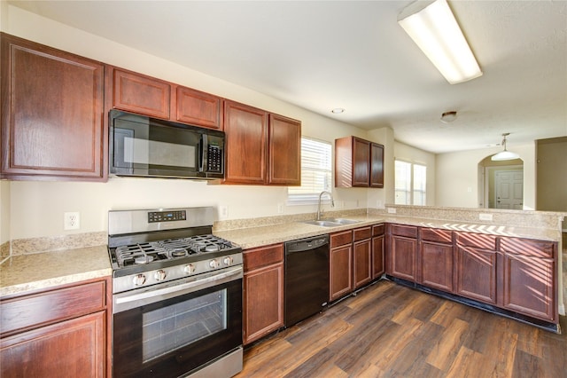 15531 Kiplands Bend Dr, Houston, TX 77014 - kitchen featuring black appliances, a sink, dark wood-style flooring, light countertops, and a peninsula