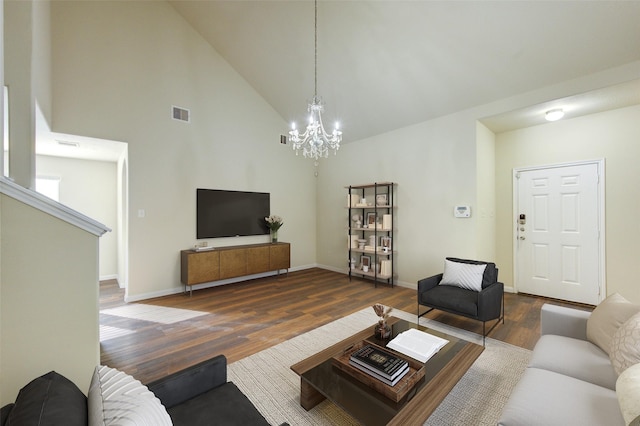 15531 Kiplands Bend Dr, Houston, TX 77014 - living area with dark wood finished floors, a chandelier, high vaulted ceiling, and baseboards