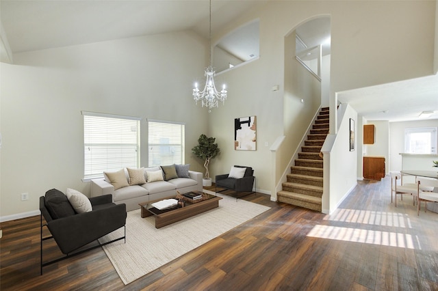 15531 Kiplands Bend Dr, Houston, TX 77014 - living room featuring high vaulted ceiling, stairway, dark wood-style flooring, a chandelier, and baseboards