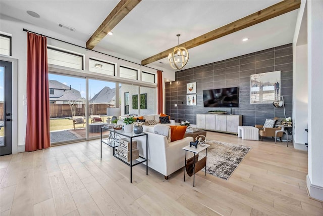 1922 Kessler Point Pl, Katy, TX 77493 - living area with wood finished floors, beam ceiling, tile walls, an accent wall, and a chandelier