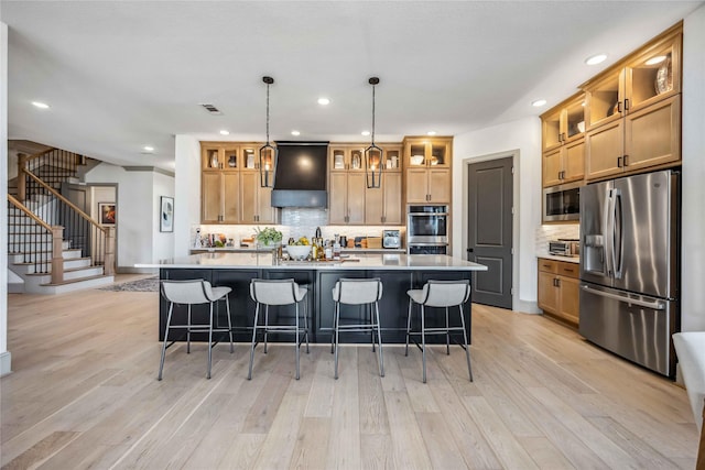 1922 Kessler Point Pl, Katy, TX 77493 - kitchen with appliances with stainless steel finishes, custom exhaust hood, tasteful backsplash, light wood-style floors, and recessed lighting