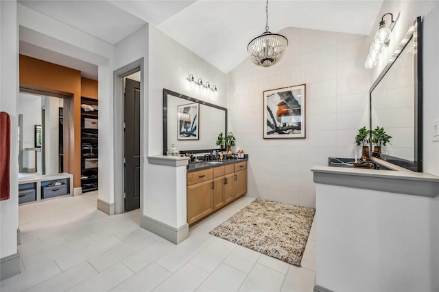 1922 Kessler Point Pl, Katy, TX 77493 - bathroom with vaulted ceiling, tile walls, a chandelier, tile patterned flooring, and vanity