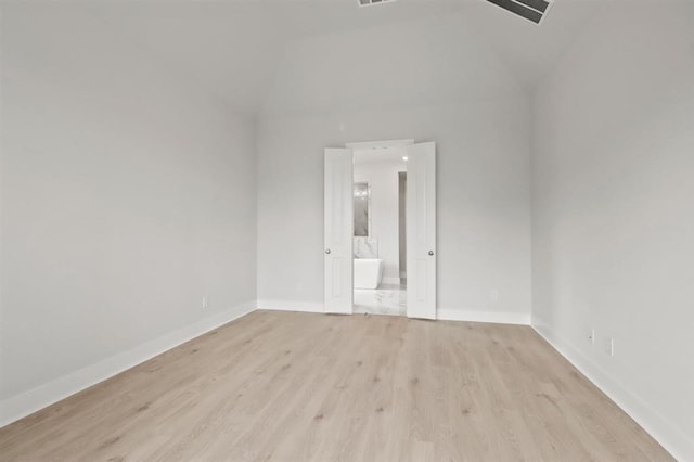 15212 Deseo Dr, Conroe, TX 77302 - empty room featuring light wood-type flooring, baseboards, and lofted ceiling